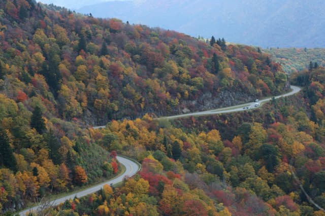 The parkway winding through mountainsides of red, orange and yellow trees