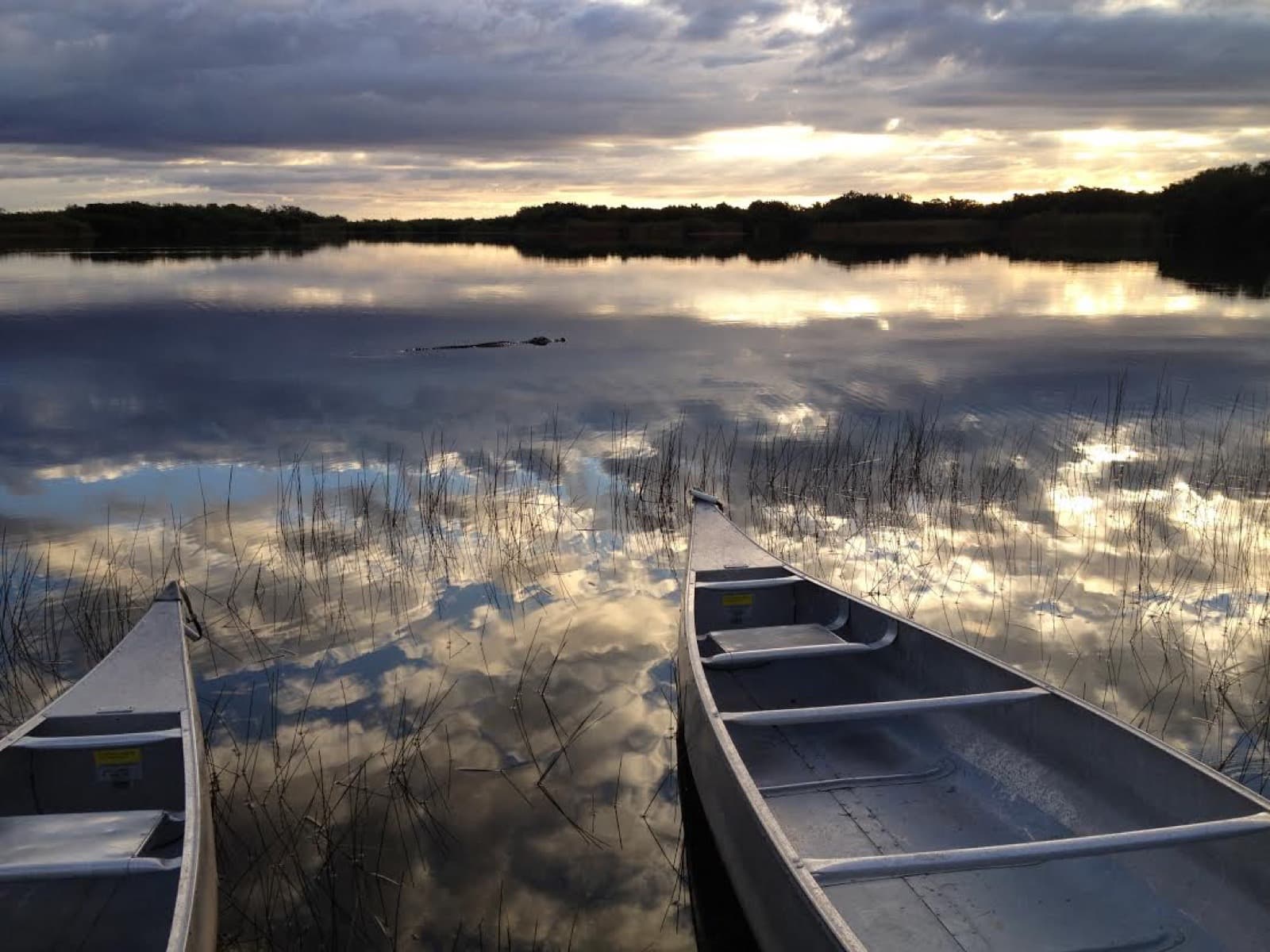 Two canoes at Nine Mile Pond during sunset