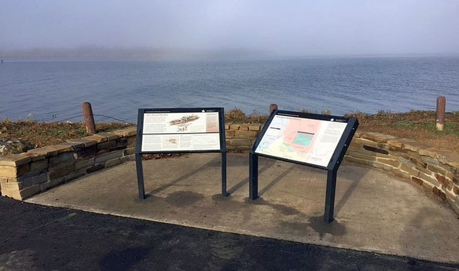 An interpretive panel about the Trail of Tears with the Arkansas River behind it