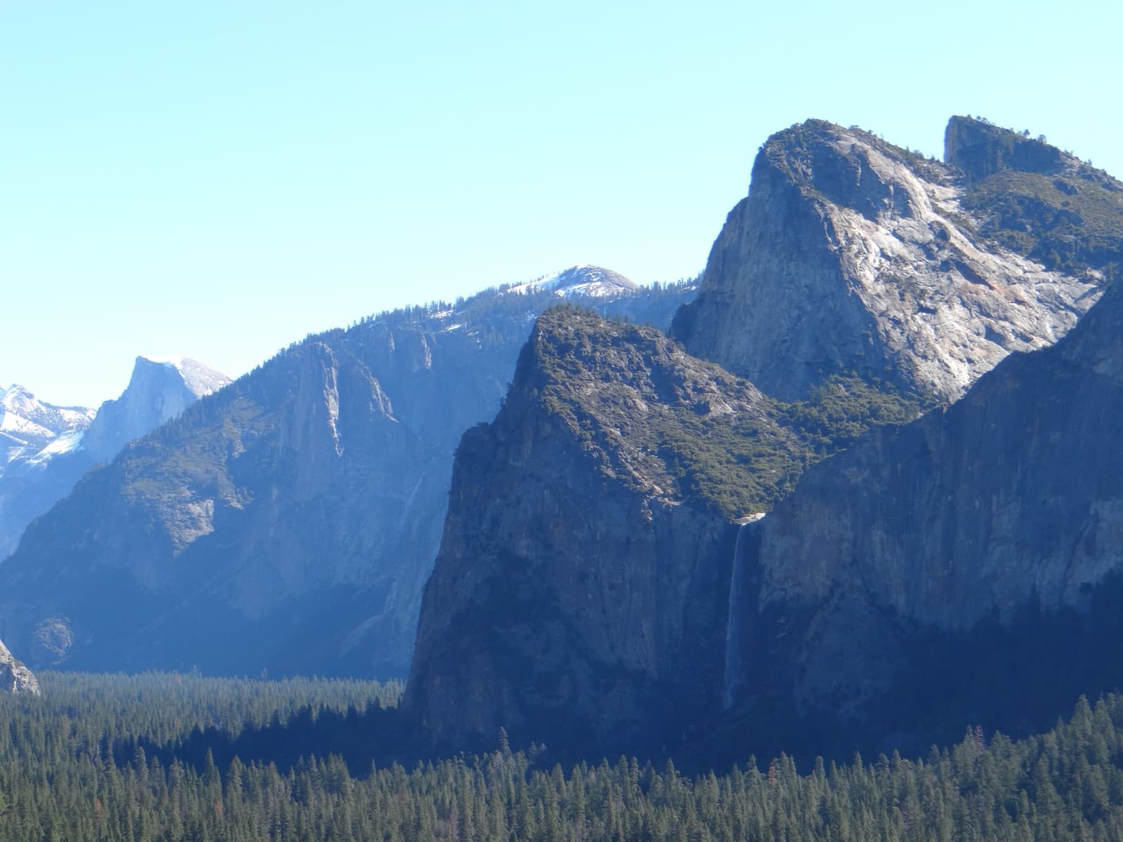 Bridalveil Fall dropping from a cliff on the south side of Yosemite Valley, seen from Tunnel View