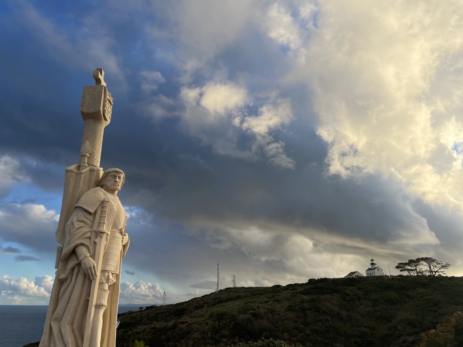 Cabrillo statue and Old Point Loma Lighthouse at sunset